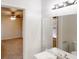 Bright bathroom featuring a vanity with modern lighting fixture and a view to the bedroom at 3359 Mansfield Ln, Snellville, GA 30039