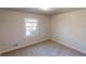 Cozy bedroom featuring a window for ample natural light and neutral carpeting at 3359 Mansfield Ln, Snellville, GA 30039