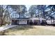 Charming one-story home with brick facade, covered entrance, and mature trees at 3359 Mansfield Ln, Snellville, GA 30039