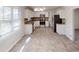 Open-concept kitchen with stainless appliances, granite countertops, and ample natural light at 3359 Mansfield Ln, Snellville, GA 30039