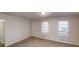 Inviting living room with neutral tones, carpeted floors, and large windows at 3359 Mansfield Ln, Snellville, GA 30039