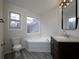 Bathroom featuring a tub, dual windows, light gray wood floors, vanity, and modern lighting at 6334 Milo Dr, Austell, GA 30168