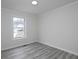 Bedroom featuring a window and light gray wood floors throughout the space at 6334 Milo Dr, Austell, GA 30168