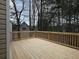 Wide wooden deck with a view of the trees and a shed in the background at 6334 Milo Dr, Austell, GA 30168