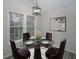 Cozy dining area featuring a round glass table set and modern lighting at 6334 Milo Dr, Austell, GA 30168