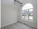 Dining area featuring a large arched window, modern lighting, and gray vinyl floors at 6334 Milo Dr, Austell, GA 30168