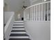 Bright entryway featuring stairs with white banister, a high ceiling, and contemporary neutral color palette at 6334 Milo Dr, Austell, GA 30168