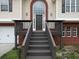 Two-story home featuring brick accents, steps, and a two-car garage at 6334 Milo Dr, Austell, GA 30168
