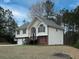 Exterior side view of a well-maintained home featuring a manicured lawn and mature trees in a serene setting at 6334 Milo Dr, Austell, GA 30168
