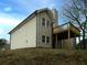 Tan home featuring a chimney and a wooden porch at 6334 Milo Dr, Austell, GA 30168