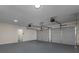 Garage featuring two garage doors, painted floor, recessed lighting and white walls at 6334 Milo Dr, Austell, GA 30168