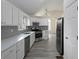 Modern kitchen featuring stainless steel appliances, gray backsplash, and white cabinets at 6334 Milo Dr, Austell, GA 30168