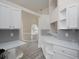 Open-concept kitchen boasting white cabinets, quartz countertops, and seamless flow into the living area at 6334 Milo Dr, Austell, GA 30168
