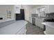 Spacious kitchen with white cabinets, stainless appliances, and breakfast bar overlooking the living area at 6334 Milo Dr, Austell, GA 30168