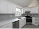 Bright kitchen with white cabinets, quartz counters, stainless appliances, and gray subway tile at 6334 Milo Dr, Austell, GA 30168