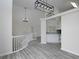 Open-concept living room with modern light fixtures and light gray wood floors throughout the space at 6334 Milo Dr, Austell, GA 30168