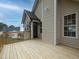 Wood porch on a light tan house showing windows and trim at 6334 Milo Dr, Austell, GA 30168