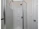 Shower stall featuring a shower head, built in shelves, and glass doors at 6334 Milo Dr, Austell, GA 30168