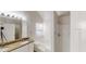 Bright bathroom featuring double sinks with granite countertop, bathtub, and shower at 6643 Hill Creek Cv, Lithonia, GA 30058