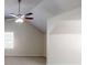 Bright bedroom featuring a vaulted ceiling with fan, and a window for natural light at 6643 Hill Creek Cv, Lithonia, GA 30058