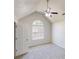 Bedroom with vaulted ceiling, ceiling fan, carpet and window offering natural light at 6643 Hill Creek Cv, Lithonia, GA 30058