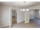 Open dining room showcasing hardwood floors, chandelier and connections to other spaces at 6643 Hill Creek Cv, Lithonia, GA 30058