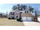Charming two-story brick home with a two-car garage and well-manicured landscaping at 6643 Hill Creek Cv, Lithonia, GA 30058