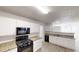 Modern kitchen featuring white cabinets, hardwood floors and modern appliances at 6643 Hill Creek Cv, Lithonia, GA 30058