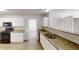 Bright kitchen features white cabinets, granite countertops, stainless steel appliances, and double bowl sink at 6643 Hill Creek Cv, Lithonia, GA 30058