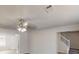 Spacious living room with ceiling fan, hardwood floors and adjacent staircase at 6643 Hill Creek Cv, Lithonia, GA 30058