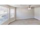 Bright living room with large windows, ceiling fan and hardwood floors at 6643 Hill Creek Cv, Lithonia, GA 30058