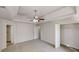 Spacious main bedroom featuring tray ceiling, fan, carpet, and an en-suite bathroom at 6643 Hill Creek Cv, Lithonia, GA 30058