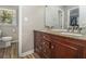 Bathroom featuring a double vanity with granite countertop and wood plank flooring at 284 Regal Dr, Lawrenceville, GA 30046