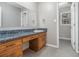 Simple bathroom featuring a vanity, sink, and mirror. A window provides natural light in the room at 284 Regal Dr, Lawrenceville, GA 30046