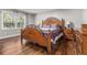Bedroom featuring a wooden bed frame, hardwood floors, and a bright window at 284 Regal Dr, Lawrenceville, GA 30046