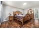 Bedroom with hardwood floors, skylight, and a large wooden bed frame at 284 Regal Dr, Lawrenceville, GA 30046
