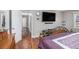 Bedroom with wood floors, TV, and access to the hall at 284 Regal Dr, Lawrenceville, GA 30046