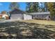Charming home features a two-car garage, fresh landscaping, and a grassy front lawn at 284 Regal Dr, Lawrenceville, GA 30046