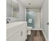 Well-lit bathroom featuring a glass shower, white vanity, and sleek fixtures at 2870 Pharr Court South Nw # 1202, Atlanta, GA 30305