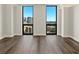 Inviting bedroom featuring two large windows with views of the city at 2870 Pharr Court South Nw # 1202, Atlanta, GA 30305