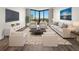 Bright living room features large windows with city views and sleek modern furnishings at 2870 Pharr Court South Nw # 1202, Atlanta, GA 30305