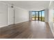 Bright living space features updated hardwood floors and a large window with a city view at 2870 Pharr Court South Nw # 1202, Atlanta, GA 30305