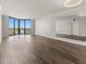 Open living space features updated hardwood floors, large windows, and a wall mirror at 2870 Pharr Court South Nw # 1202, Atlanta, GA 30305