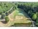 Overhead shot features a baseball field, basketball court, and walking path nestled within a green, tree-lined community at 525 Appalachian Pl, Canton, GA 30114