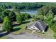 Aerial view showing a community clubhouse near a lake, surrounded by lush greenery and well-kept landscaping at 525 Appalachian Pl, Canton, GA 30114