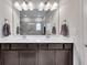 Bright bathroom featuring double sinks with modern fixtures and large mirror at 525 Appalachian Pl, Canton, GA 30114