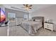 Comfortable bedroom features a ceiling fan, dresser, and large windows at 525 Appalachian Pl, Canton, GA 30114