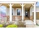 Welcoming front porch with stone accents and a comfortable seating area at 525 Appalachian Pl, Canton, GA 30114