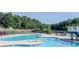 Large community pool surrounded by lush greenery and comfortable lounge chairs, providing a resort-like atmosphere at 525 Appalachian Pl, Canton, GA 30114