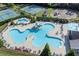 Aerial view of a community pool featuring a slide, splash pad, and plenty of seating with tennis courts and playground nearby at 525 Appalachian Pl, Canton, GA 30114